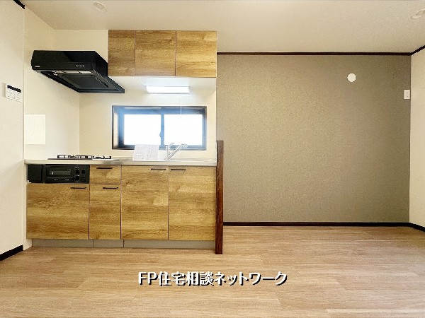 木目調キッチンと相性の良い落ち着いたアクセントクロスが空間を上品に引き締めるLDK。家具の色を選ばず、インテリアが映えるデザイン性の高い一室です。